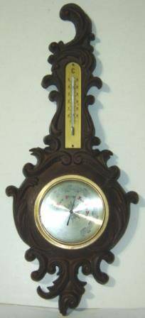 Wall Barometer with Thermometer mounted on a fancy compound frame.