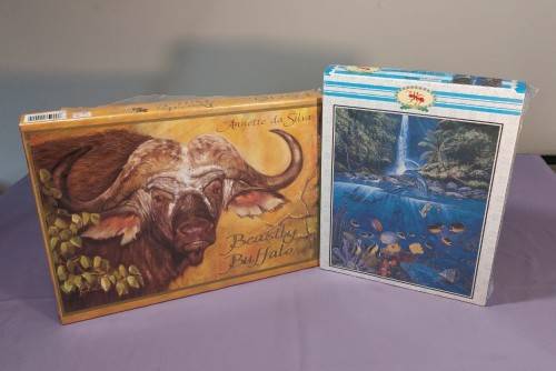 TWO PUZZLE BOXES  1500 PIECE BEASTLY BUFFALO  500 PIECE ISLAND OCEAN SCENE