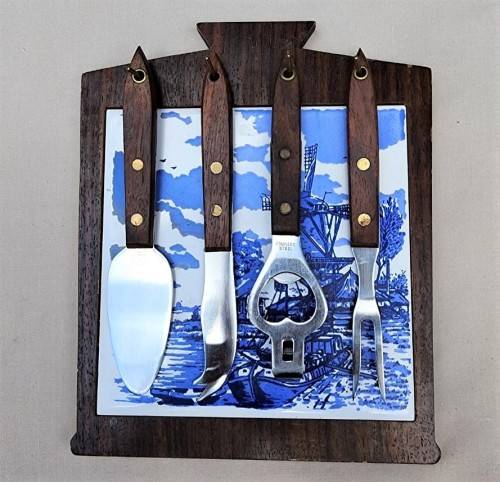 A DUTCH CERAMIC PLATE UTENSIL HOLDER WITH PRONGED CHEESE KNIFE AND SKEWER