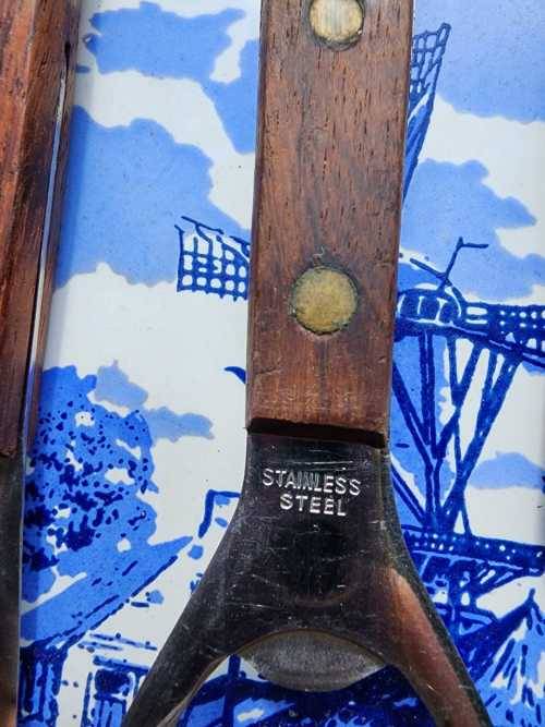 A DUTCH CERAMIC PLATE UTENSIL HOLDER WITH PRONGED CHEESE KNIFE AND SKEWER