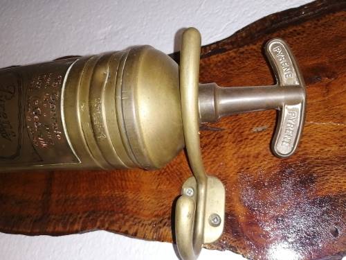 Fireextinguisher mounted on piece of Olienwood
