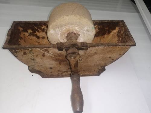 Grinding stone in cast iron holder with handle - very old and with some damage