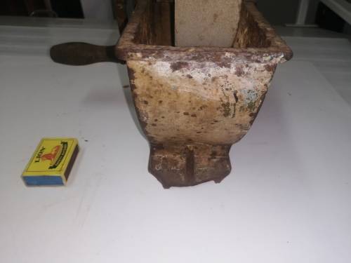 Grinding stone in cast iron holder with handle - very old and with some damage