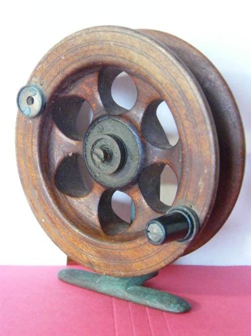 Antique wooden fishing reel on brass foot - one winding lug missing