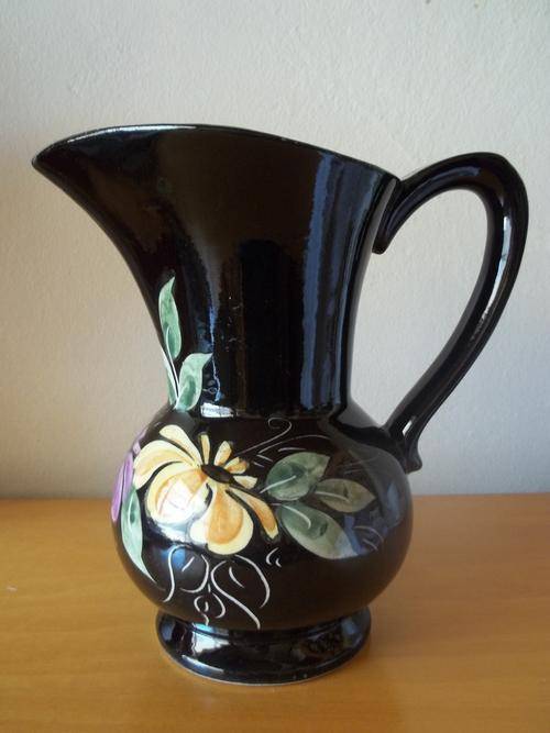 Black pitcher with flower detail