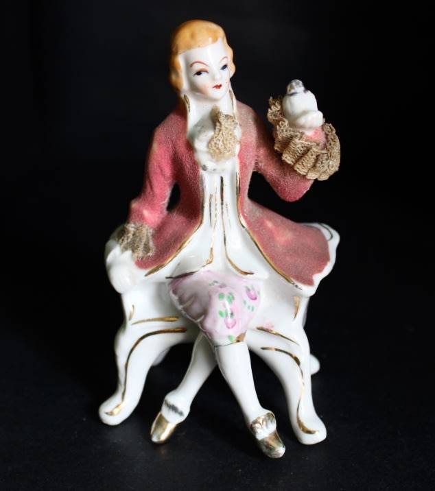 Porcelain Figurine of Man on Seat.