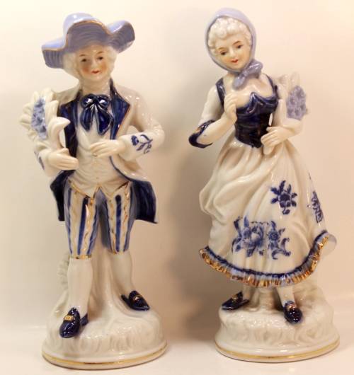 Man and Woman Matching Pair of Porcelain Ornamental Figurines in Victorian Finery.