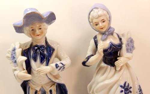 Man and Woman Matching Pair of Porcelain Ornamental Figurines in Victorian Finery.