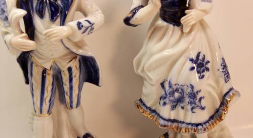 Man and Woman Matching Pair of Porcelain Ornamental Figurines in Victorian Finery.