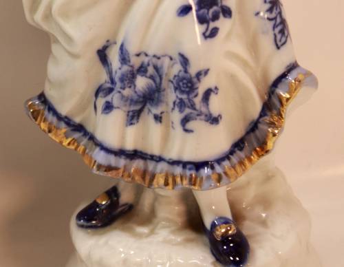 Man and Woman Matching Pair of Porcelain Ornamental Figurines in Victorian Finery.