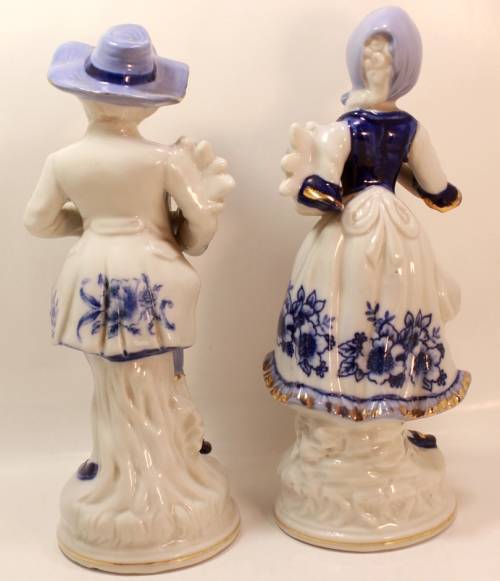 Man and Woman Matching Pair of Porcelain Ornamental Figurines in Victorian Finery.