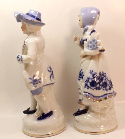 Man and Woman Matching Pair of Porcelain Ornamental Figurines in Victorian Finery.