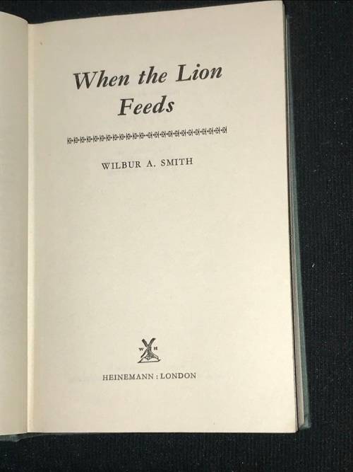 WHEN THE LION FEEDS BY WILBUR SMITH