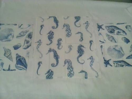 Small tablecloth with four napkins/ place mats. Printed blue on white cotton material.