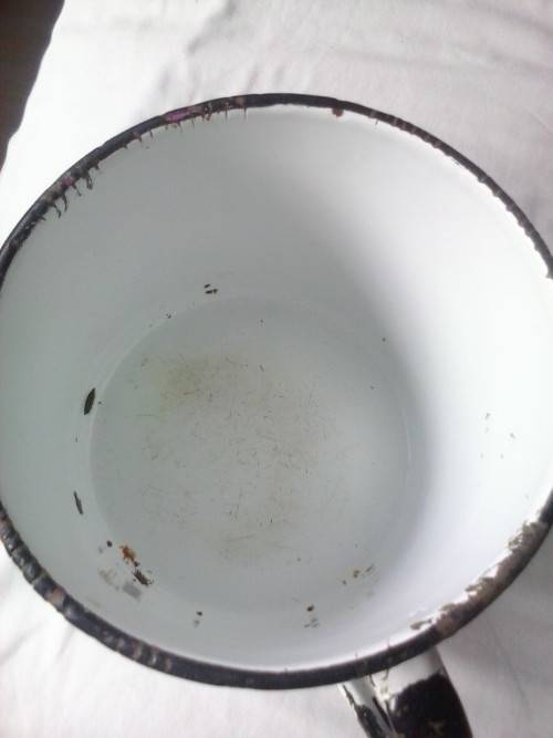 Large enamel jug, slightly damaged, white with black trim, 14.5cm high x 16cm diameter