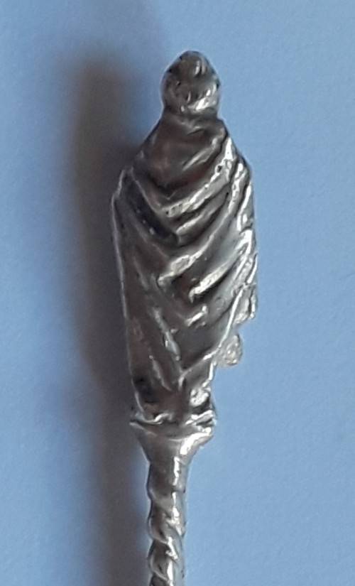 An antique solid silver spoon with figural finial. Arthur Graf, London, 1911.
