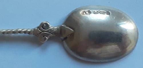 An antique solid silver spoon with figural finial. Arthur Graf, London, 1911.