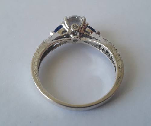Solid sterling silver trilogy ring with clear centre stone and blue side stones. Size: N (17mm)