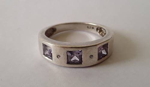 Solid sterling silver band ring with flush set purple stones. Size: N (17mm)