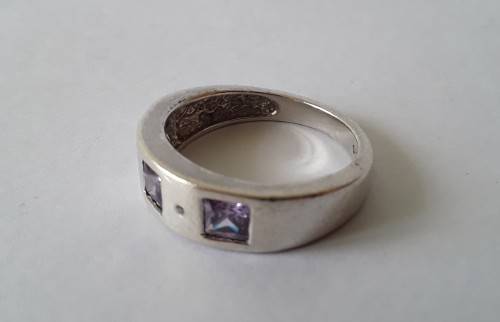 Solid sterling silver band ring with flush set purple stones. Size: N (17mm)