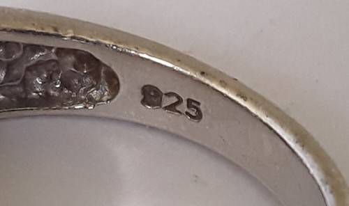 Solid sterling silver band ring with flush set purple stones. Size: N (17mm)