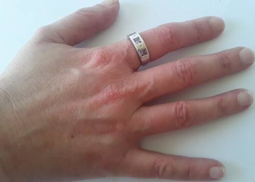 Solid sterling silver band ring with flush set purple stones. Size: N (17mm)