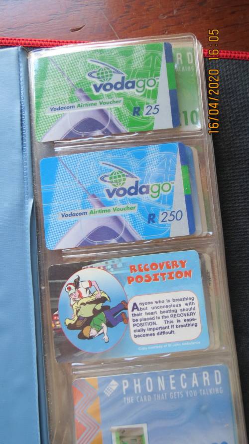 collection of 40 telephone cards in album, as per photo