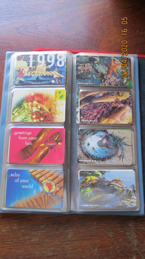 collection of 40 telephone cards in album, as per photo