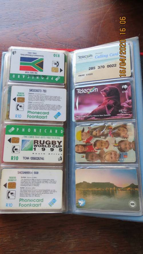collection of 40 telephone cards in album, as per photo