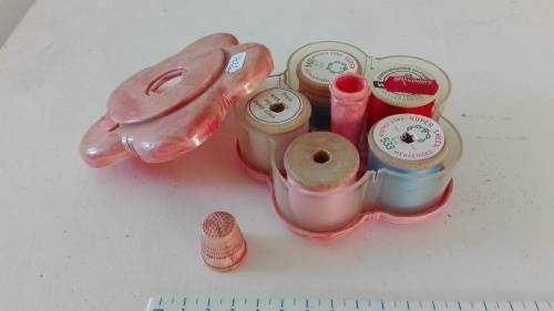 very attractive container with cottons and thimble on the top, as per photo