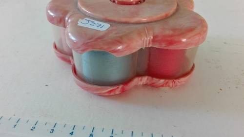 very attractive container with cottons and thimble on the top, as per photo