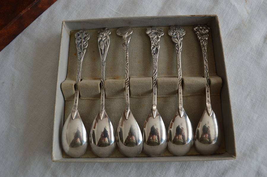 6 silver plated demitasse teaspoons with a different flower on the end of each handle,Very pretty !
