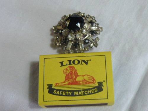 RAISED SLVER TONED BROOCH WITH BLACK STONED AND BLING