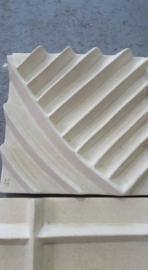 Unique plastered finish/cement type material. Wall hanging--great appeal,funky,modern!!