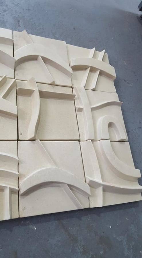 Unique plastered finish/cement type material. Wall hanging--great appeal,funky,modern!!