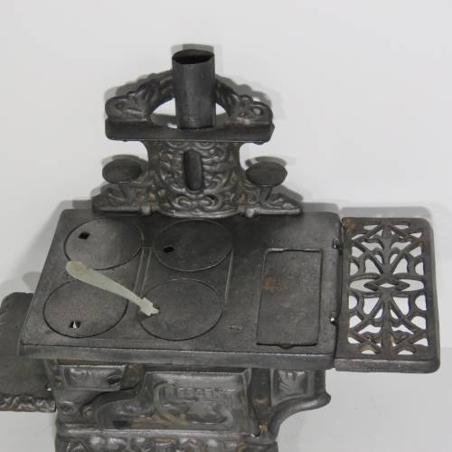 Miniature Crescent black iron stove with some additional items - 14 x 21 cm
