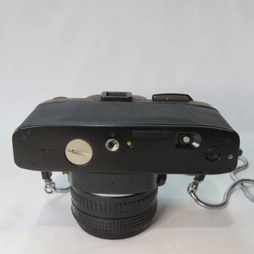 Ricoh KR-10 camera in pouch with Rikenon 1:2 50 mm lens and booklets