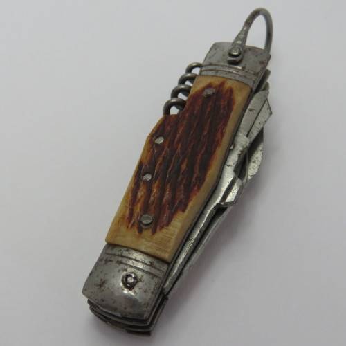 Small vintage pocket knife with corkscrew, Scissors, tin opener and blade - Unusual