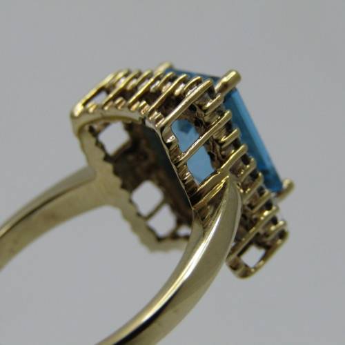 9kt Gold ring with 3.5ct blue topaz and small diamonds of 0.28ct in total - weighs 4.8g - size O/7