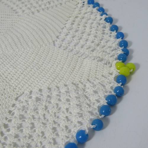 Old doily with blue and yellow beads handmade