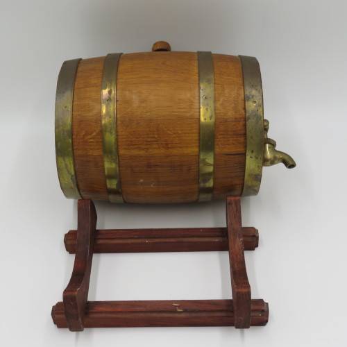 Vintage wooden wine barrel on stand with brass tap