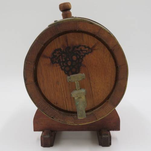 Vintage wooden wine barrel on stand with brass tap