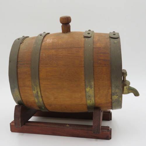 Vintage wooden wine barrel on stand with brass tap