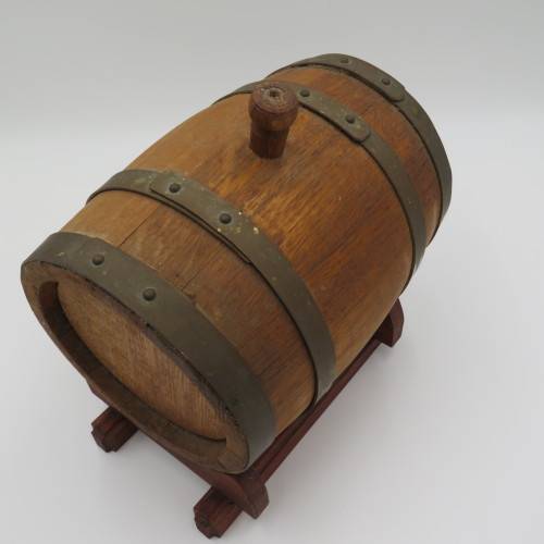 Vintage wooden wine barrel on stand with brass tap