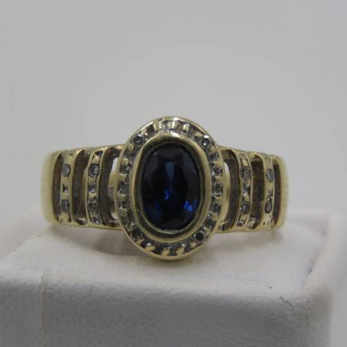 9 kt Gold ring with 12 Diamonds and centre stone dark blue ( Ring Size - K 1/2)