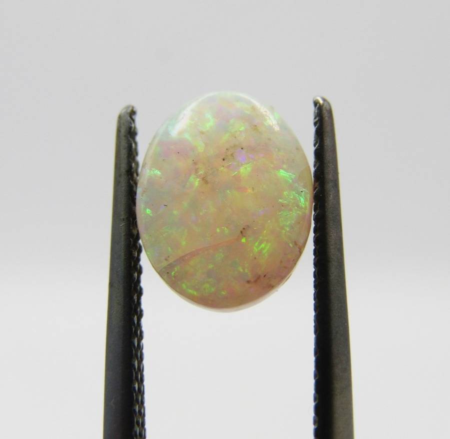 Beautiful orange & green flashes Opal of 1,21 carat - Oval Cabochon white opal
