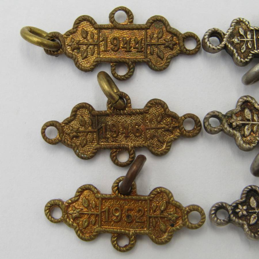 Lot of 9 St John`s Ambulance date labels - some silver