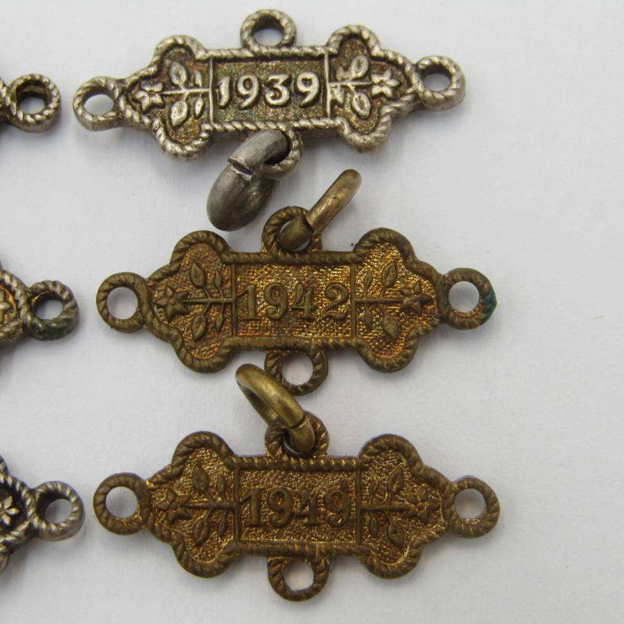 Lot of 9 St John`s Ambulance date labels - some silver