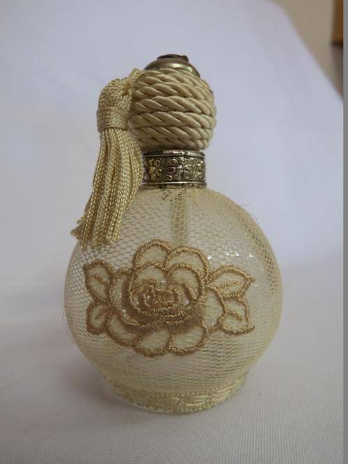 Antique glass perfume bottle with netting cover - as per photo