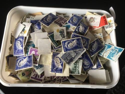 Ice cream tub full of off paper South Africa stamps R1 start